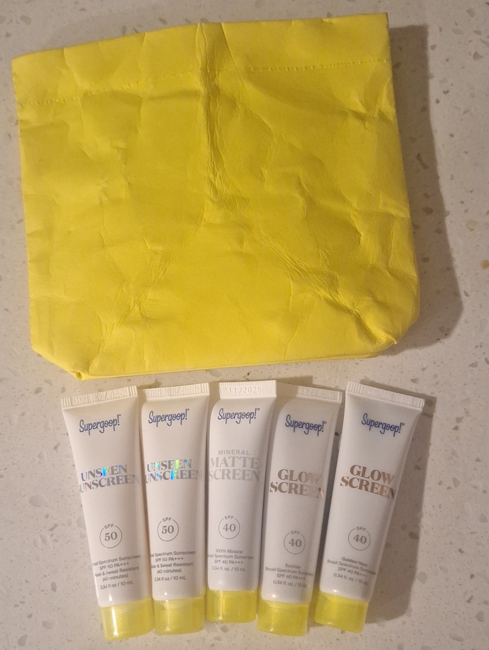 Supergoop! Sunscreen Tubes with Bright Yellow Pouch